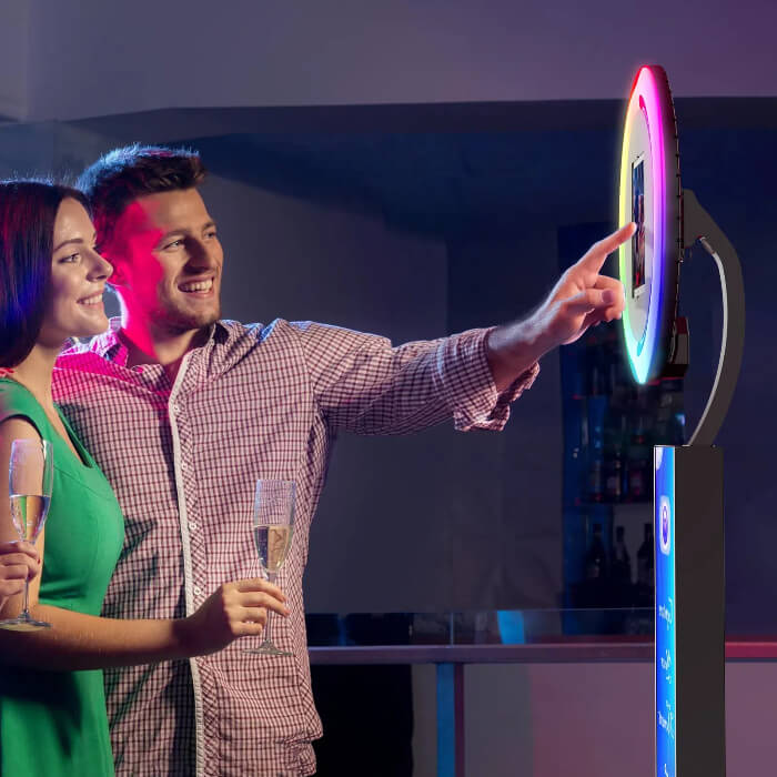 Guests using a colorful interactive photo booth